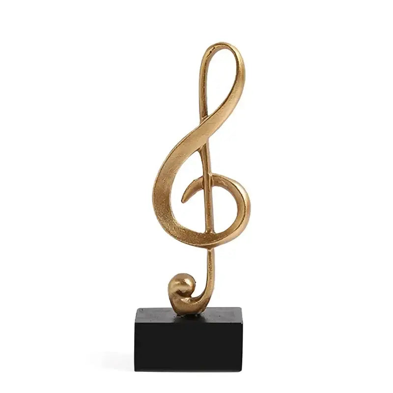 Escultura de clave de sol dourada em base preta para decoração musical Ricaly