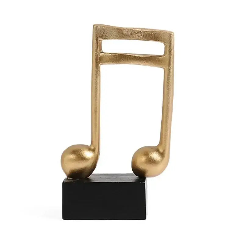 Escultura de nota musical dourada em base preta para decoração de Ricaly